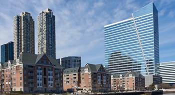 Jersey City, NJ USA - February 24 2021: A view of the Newport, Jersey City Waterfront area, showing the low-rise Avalon Cove apartments in the foreground, 480 Washington Blvd (2005) office tower on the right and the two 50 story Monaco apartment towers (2011) in the background.