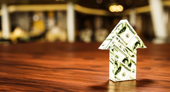 As Costs Rise, So Do Carrying Charges Arrow with dollar bills pointing up. Concept shot for currency exchange rate going up, inflation, economic boom