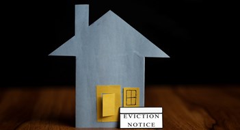 Removals, Ejections, & Evictions in Condos & Co-ops eviction notice sticker IN front of door - concept showing of tenant foreclosure or rent pending on black background