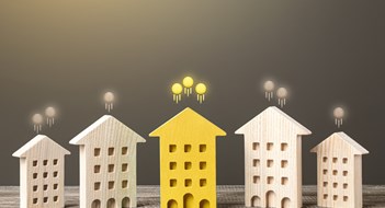 Mid-Year Maintenance Increases? Five small wooden buildings with coins floating away from rooftops