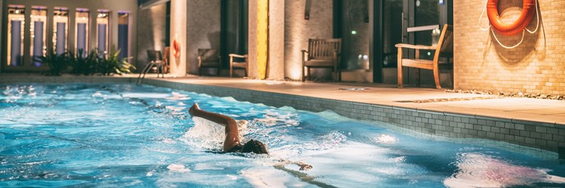 Swimmer exercising in a condo's indoor pool 