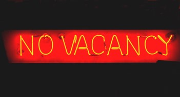 Red neon sign of "No Vacancy" at night