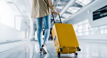 International airport terminal. Asian beautiful woman with luggage and walking in airport