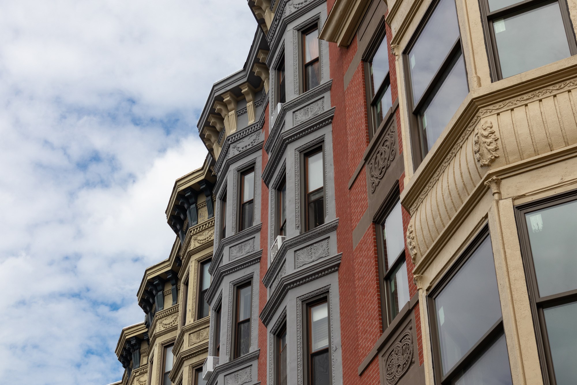 Looking up at a row of beautiful old brick brownstone homes in the downtown area of Hoboken New Jersey
