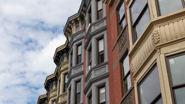 Looking up at a row of beautiful old brick brownstone homes in the downtown area of Hoboken New Jersey