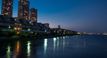 A view from a pier on the Hudson River of NJ illuminated at night