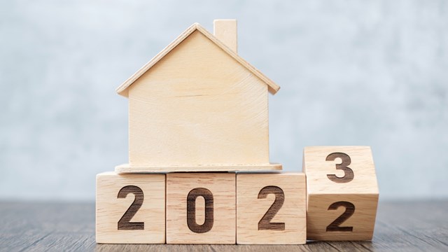 flip 2022 to 2023 block with house model. real estate, Home loan, tax, investment, financial, savings and New Year Resolution concepts