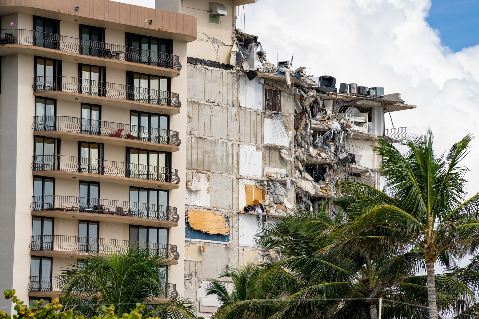 Miami Beach Surfside, FL, USA - June 26, 2021: Champlain Towers remains 2 days after collapse owners personal belongings visible hanging from the units