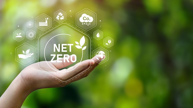 The concept of carbon neutral and net zero. natural environment A climate-neutral long-term strategy greenhouse gas emissions targets with green net center icon on hand cap and green background