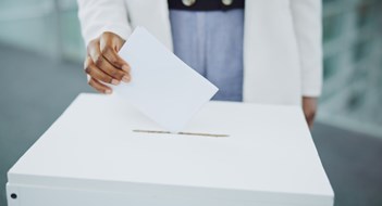Q&A: Soliciting Votes Hand, ballot and box for vote paper at president election cast, poll station choice or government selection. Person, fingers and decision document or politics support or usa process, opinion at booth