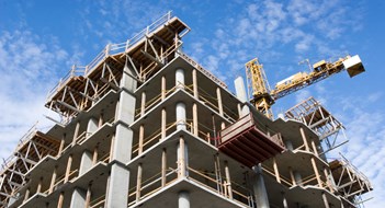 Report: NY Metro Leads US in Multifamily Construction Reinforced steel & concrete building under construction.  Safety guard rails, flyforms and tower crane