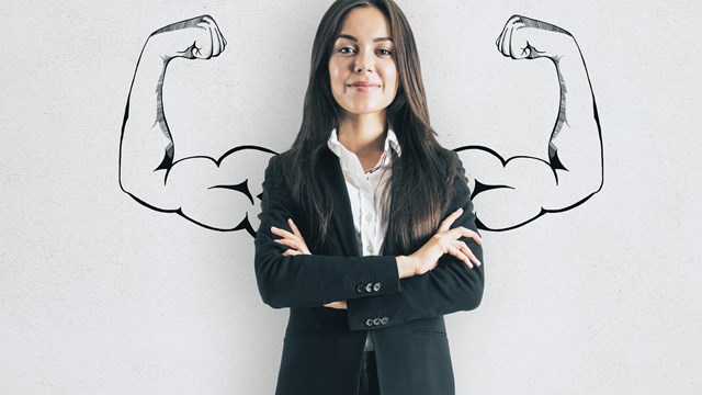Portrait of attractive young european businesswoman with drawn muscly arms. Confidence and strength concept