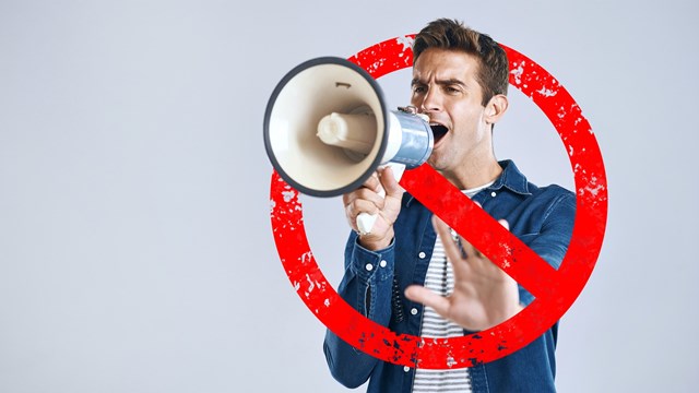 Megaphone, stop and man with protest, speech and justice on a white studio background. Person, model or activist with a bullhorn, rejection or graphic sign for warning, speaker for equality or change
